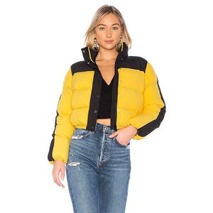 Revolve Lovers and Friends Drive Puffer Jacket in Yellow & Black.